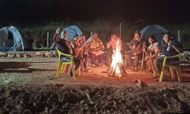 Guests around a bonfire at Sana Resort Maredumilli