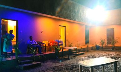 Guests seated outside the rooms at Sana Resort Maredumilli in the evening
