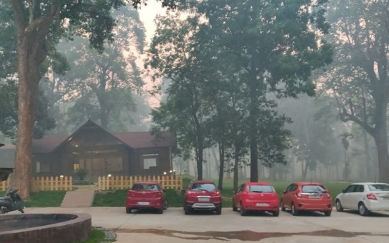 Cottage and car parking at The Woods Resort Maredumilli on a misty morning