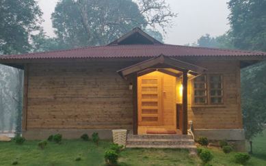 Entrance of a wooden cottage at The Woods Resort Maredumilli