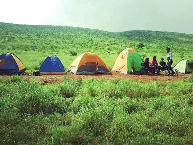 Camp site with tents on the grasslands at Gudisa hill station